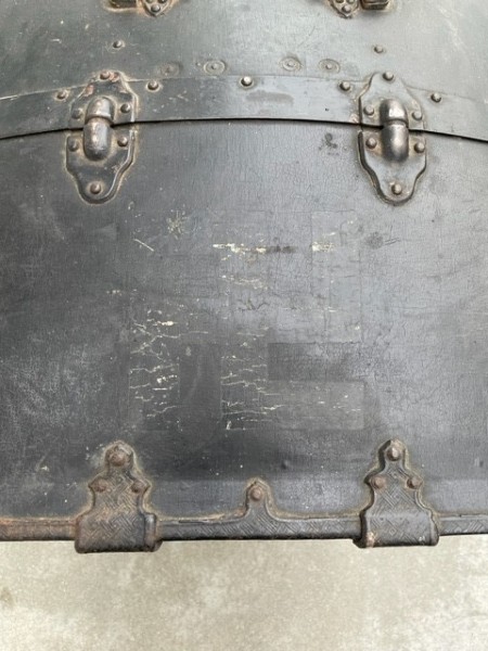 An old trunk with a swastika faintly showing.
