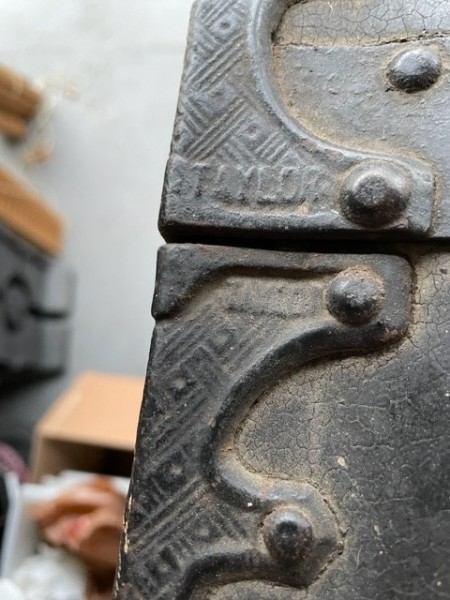 Close up of the steamer trunk's fittings and the "Taylor" name.