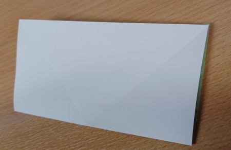 The folded piece of paper.