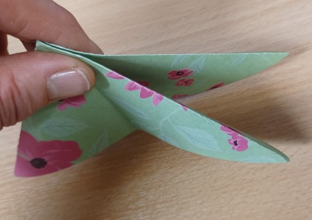 Folding the paper in the center.