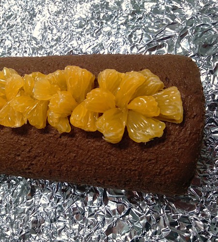 Adding mandarin oranges to the top of the roll.