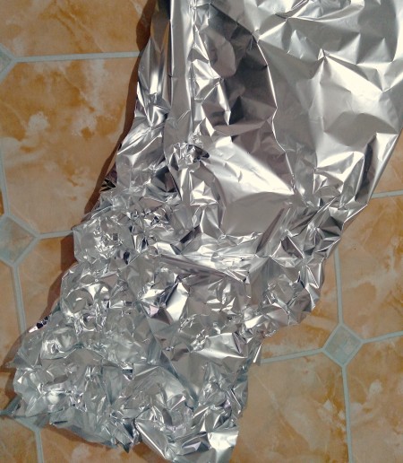 Using a piece of aluminum foil as a stand.
