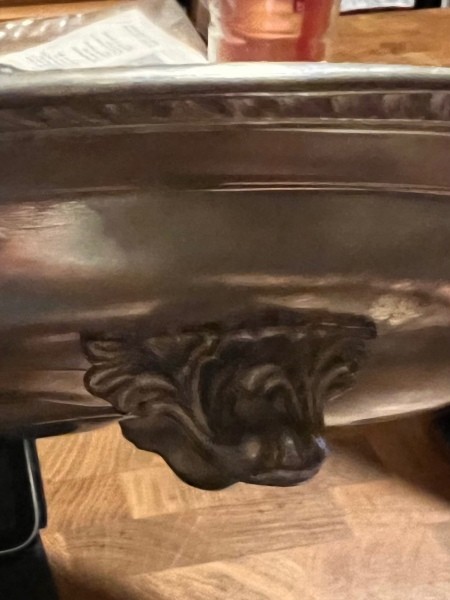 The lid for a silver tray.