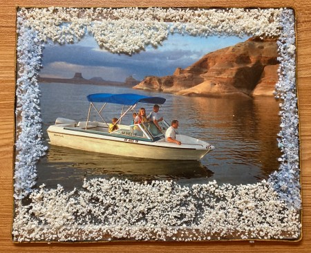 The frame with a boating picture inside.