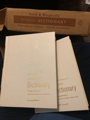 An old dictionary with a white cover.