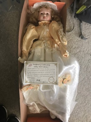 An Ashley Belle porcelain doll in a box.