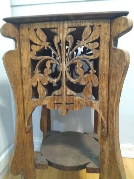 A decorative carved wooden table.