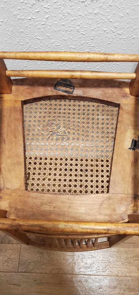 The underside of a wooden chair.