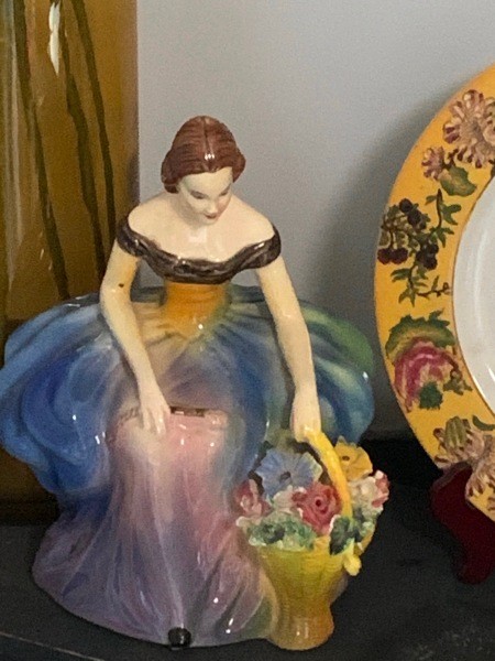 A figurine of a woman holding flowers.