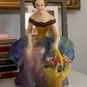 A figurine of a woman holding flowers.