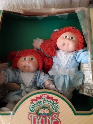Two redheaded Cabbage Patch dolls.