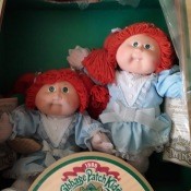 Two redheaded Cabbage Patch dolls.