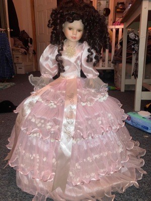A doll in a pink dress.