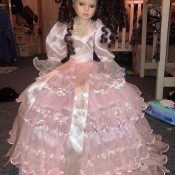 A doll in a pink dress.