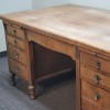 A heavy wooden desk with drawers.