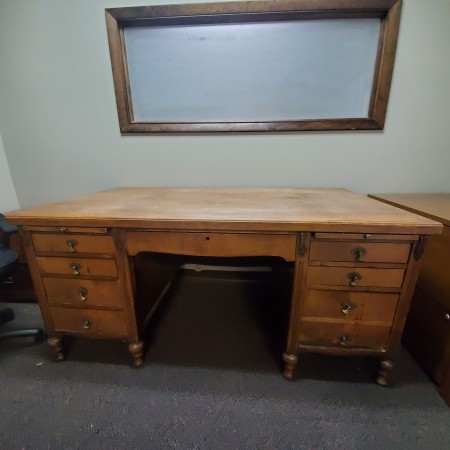 A front view of a wooden desk.