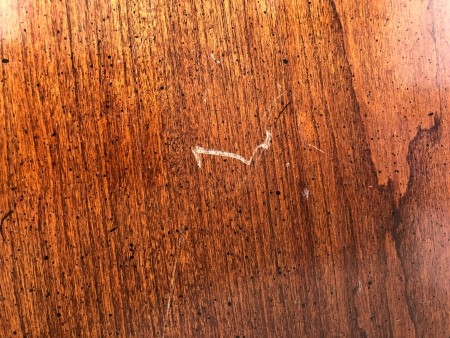 A small scratch on a table.