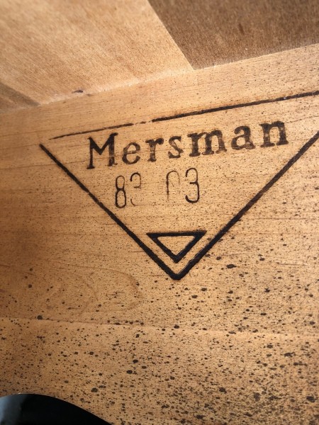 The Mersman logo on the underside of a table.