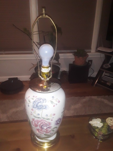 A porcelain lamp with a floral pattern.