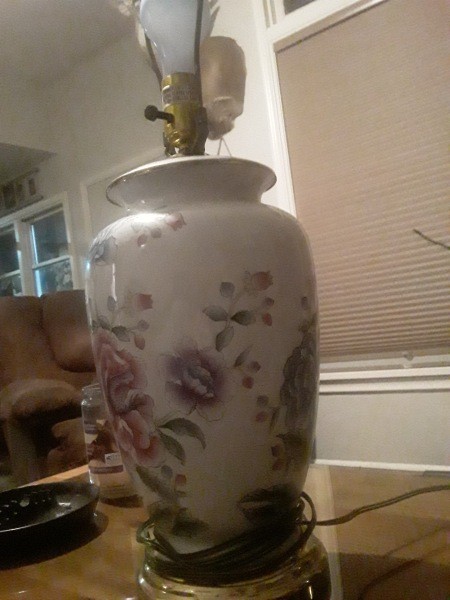 A porcelain lamp with a floral pattern.