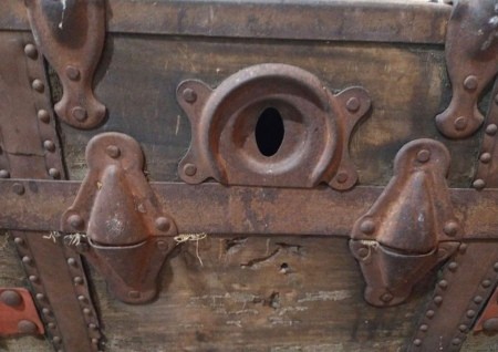 The keyhole of an old trunk.