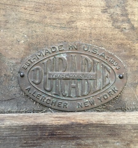 The manufacture's logo on an old trunk.