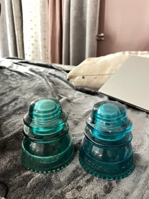 Two green glass insulators.