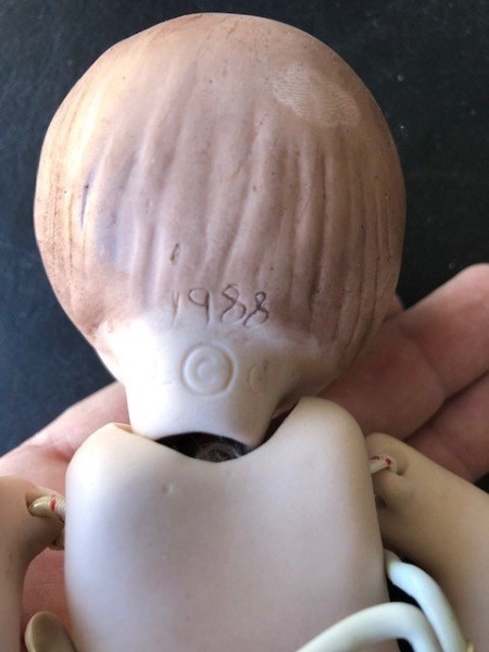The markings on the back of a doll's head.