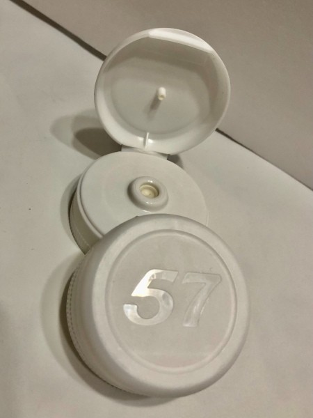 Two recycled ketchup lids.