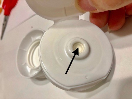 The gasket to be removed from the ketchup lids.