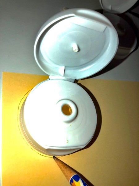 Tracing the lid on a piece of paper.