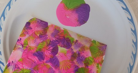 The sheet of paper covered in paint.