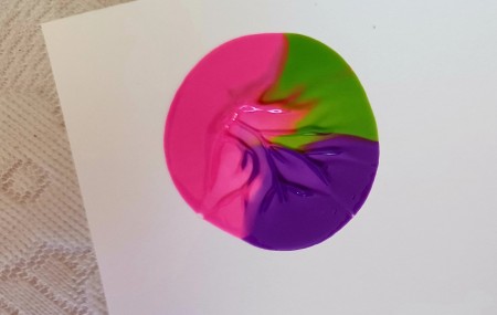 The paint placed on a piece of white paper.