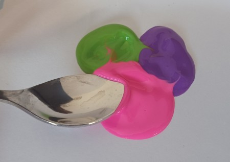 Three different colored daubs of paint.