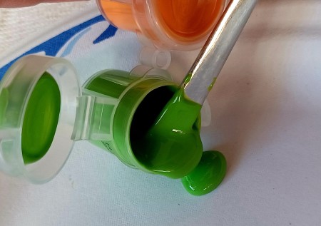 Getting green pain onto a paintbrush.