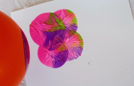 A few dots of paint on white paper.