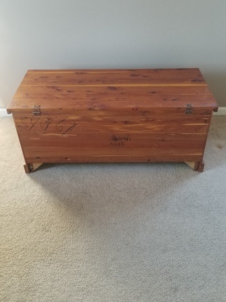 A cedar chest on a light colored floor.
