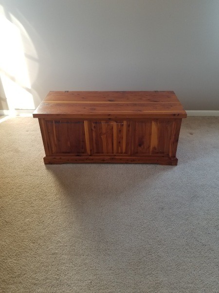 A cedar chest on a light colored floor.