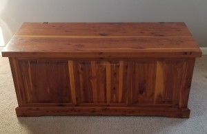 A cedar chest on a light colored floor.