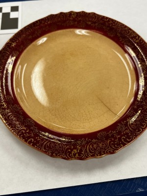 A cream colored plate with a dark brown rim.