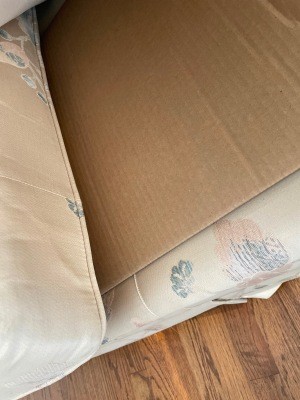Cardboard underneath a couch cushion.