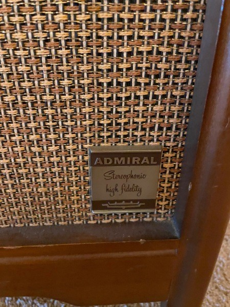 A label on the speaker of a console record player.