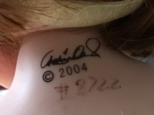 A maker's mark on the back of a doll's neck.
