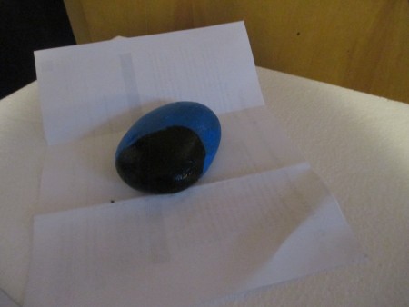 Painting the rock in blue and black.