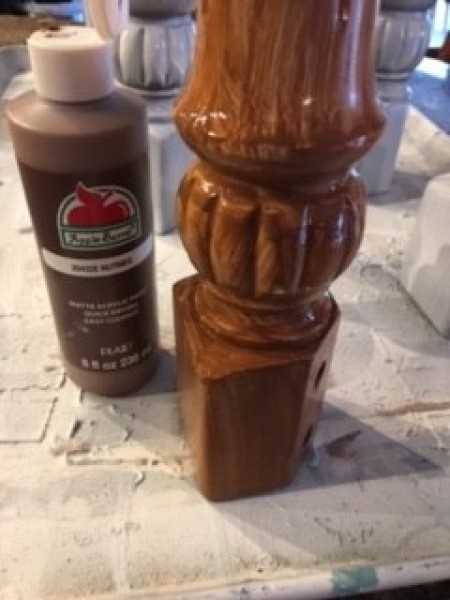 Painting the chair leg brown.