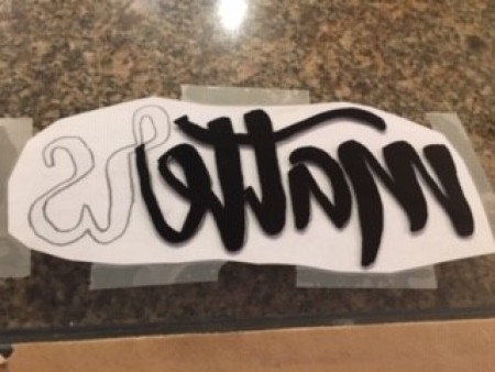 Drawing the letters on the glass.