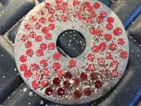 Decorating the CD with gems and glitter.