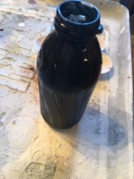 Painting the glass jar black.