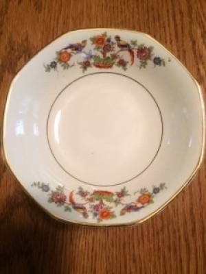 A china plate with a floral pattern and gold trim.