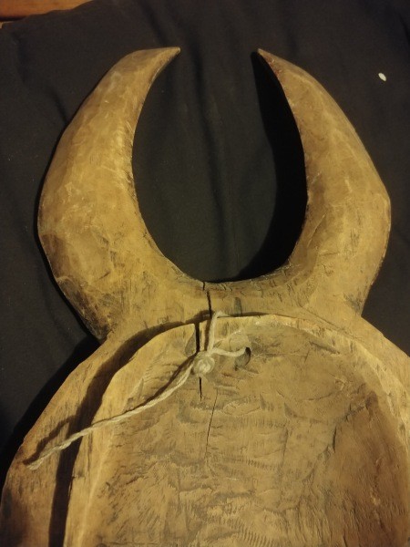 the underside of a carved wooden mask.